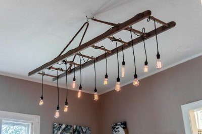 DIY Barn Ladder Chandelier made with bulb socket with a cord and light bulbs or pendant lights.