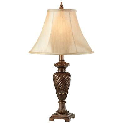 A lamp with a bell shaped lamp shade