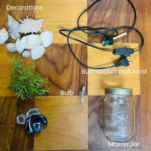 Parts and tools needed for this mason jar desk lamp - decorations, bulb socket and cord, bulb, mason jar.