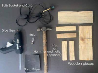 Tools needed to build DIY Wooden lamp - hammer, glue gun, sandpaper, wood, cord and socket, light bulb