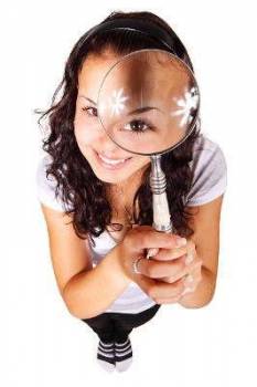 Girl holding magnifying glass