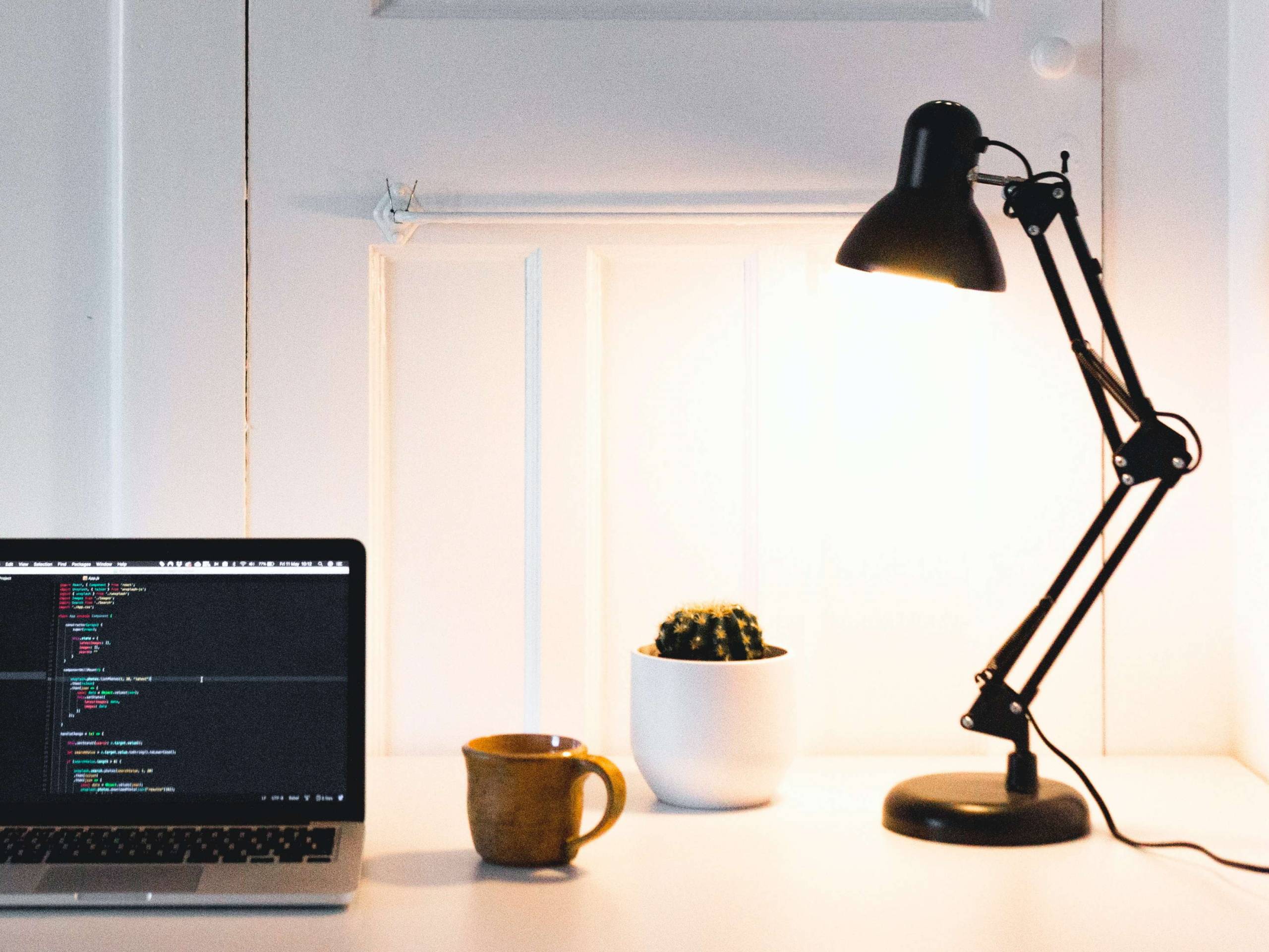 A bright desk lamp on a computer table