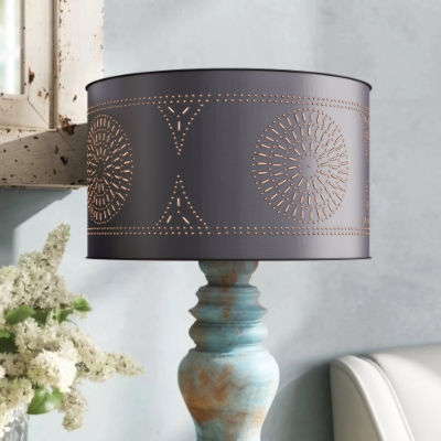 A lamp with an oval drum shaped lamp shade