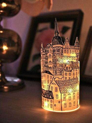 Paper cup lantern decorated with an intricately detailed medieval city drawing