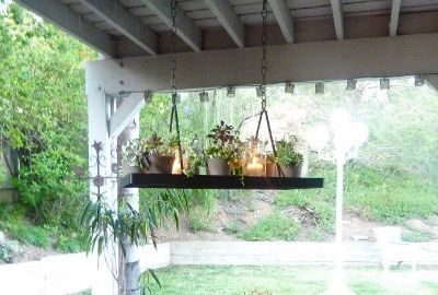 DIY a hanging wood plank with glass jars and candles
